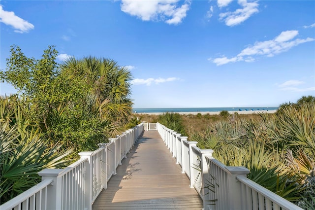 view of community featuring a beach view and a water view