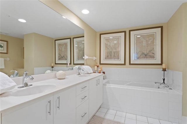bathroom with double vanity, a garden tub, tile patterned flooring, and a sink