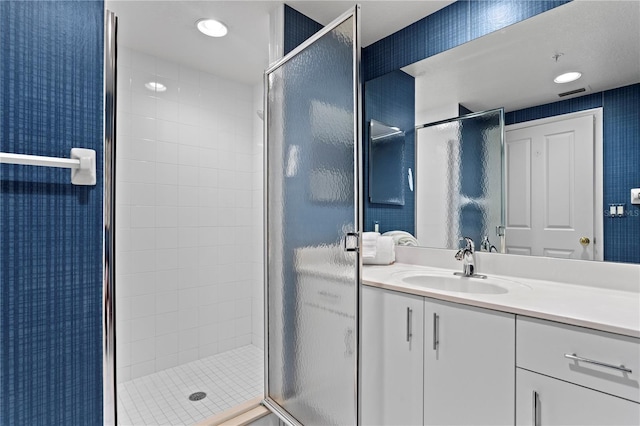 full bath with a stall shower, recessed lighting, and vanity