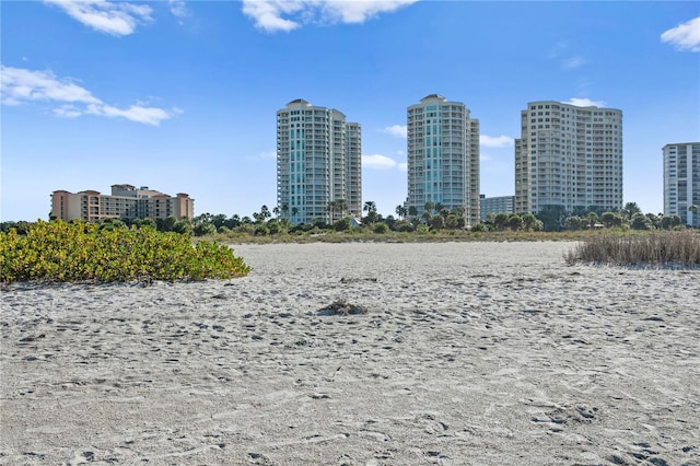 surrounding community with a water view and a city view