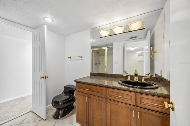 bathroom with visible vents, tile patterned flooring, a shower stall, a textured ceiling, and toilet