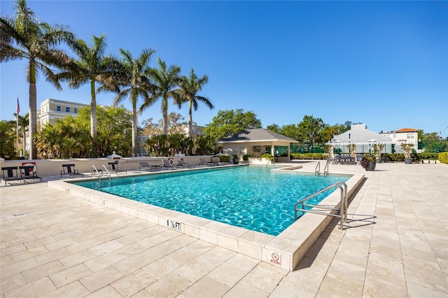 community pool featuring a patio area and fence