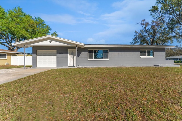 single story home featuring driveway, a front yard, a garage, and fence