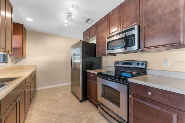 kitchen with stainless steel appliances, visible vents, and light countertops