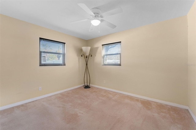 unfurnished room with light carpet, ceiling fan, and baseboards