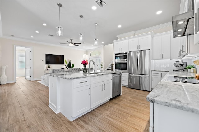 kitchen featuring ceiling fan, stainless steel appliances, visible vents, and ornamental molding