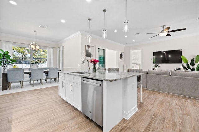 kitchen with dishwasher, light wood-style flooring, an island with sink, and a sink