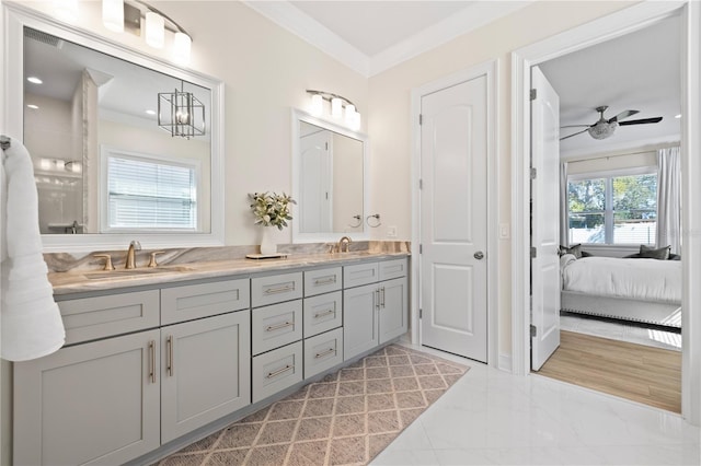 full bath with marble finish floor, ornamental molding, a ceiling fan, a sink, and double vanity