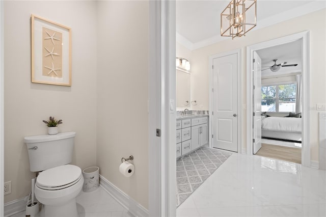 bathroom featuring vanity, baseboards, ensuite bathroom, toilet, and marble finish floor