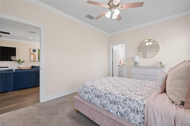 carpeted bedroom with crown molding, baseboards, and visible vents