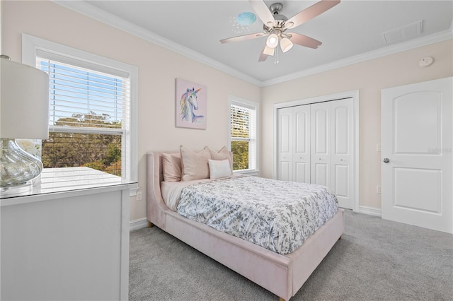 bedroom featuring crown molding, multiple windows, light colored carpet, and a closet