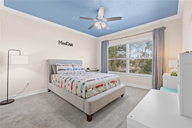 carpeted bedroom featuring crown molding, baseboards, and ceiling fan