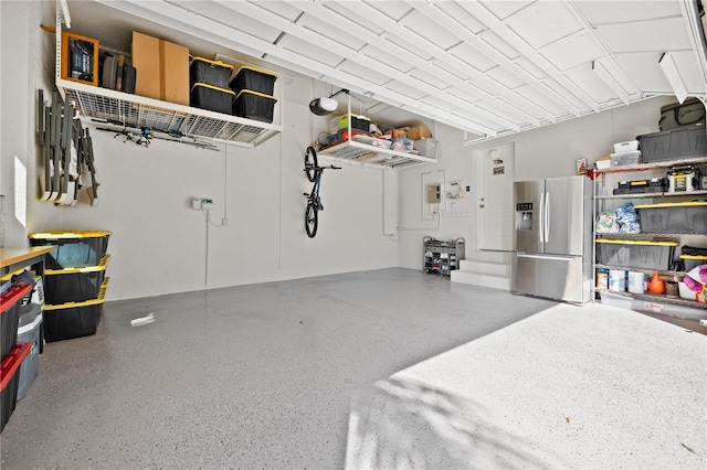 garage with stainless steel refrigerator with ice dispenser