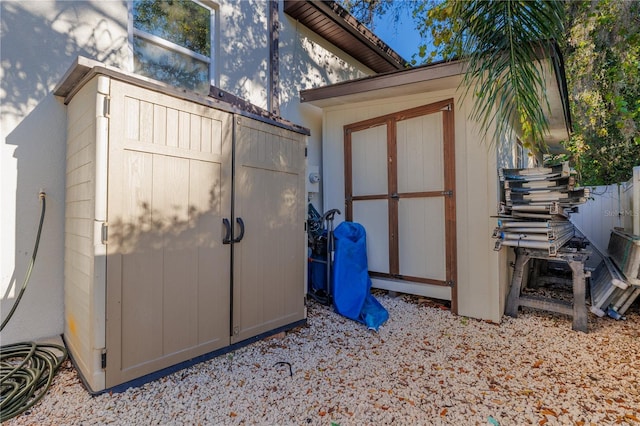 view of shed featuring fence