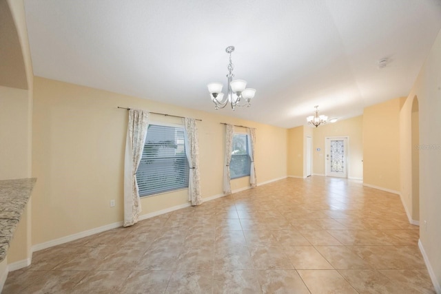 interior space featuring an inviting chandelier, baseboards, arched walkways, and vaulted ceiling