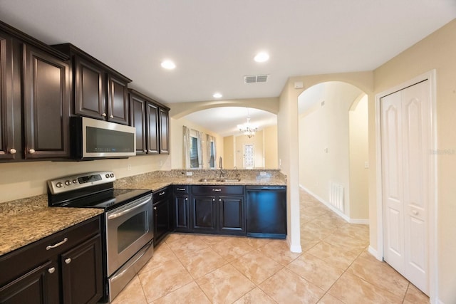 kitchen with visible vents, recessed lighting, appliances with stainless steel finishes, arched walkways, and a sink