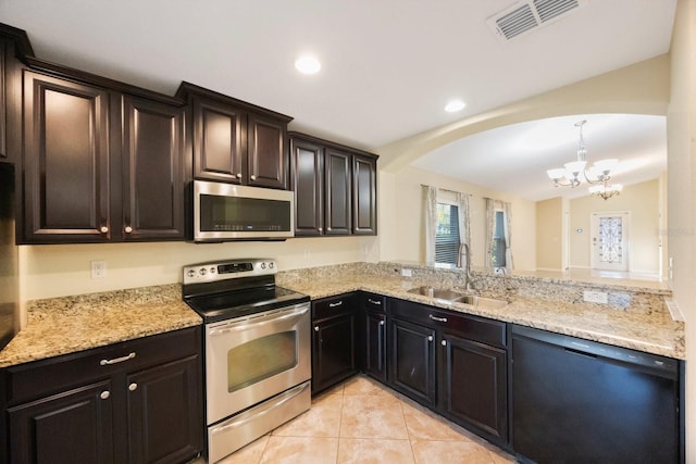 kitchen with visible vents, a notable chandelier, a sink, arched walkways, and appliances with stainless steel finishes