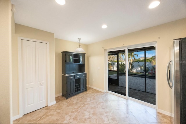 kitchen featuring recessed lighting, baseboards, pendant lighting, and freestanding refrigerator