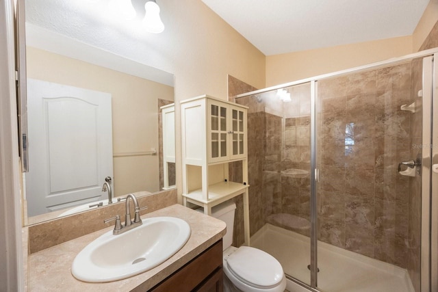 full bathroom featuring vanity, toilet, and a shower stall