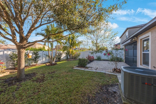 view of yard featuring cooling unit, a fenced backyard, and a patio area