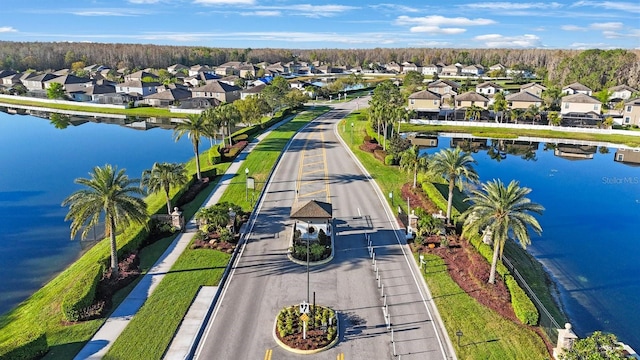 drone / aerial view featuring a residential view and a water view