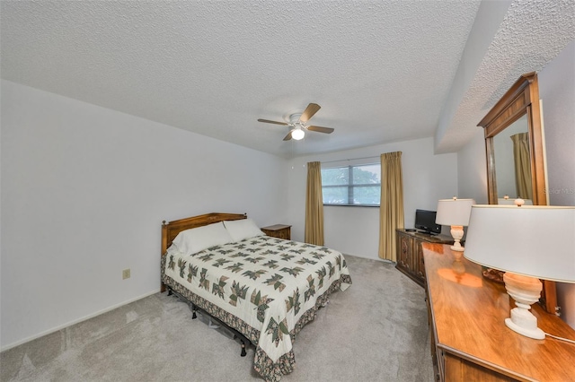 carpeted bedroom featuring ceiling fan and a textured ceiling