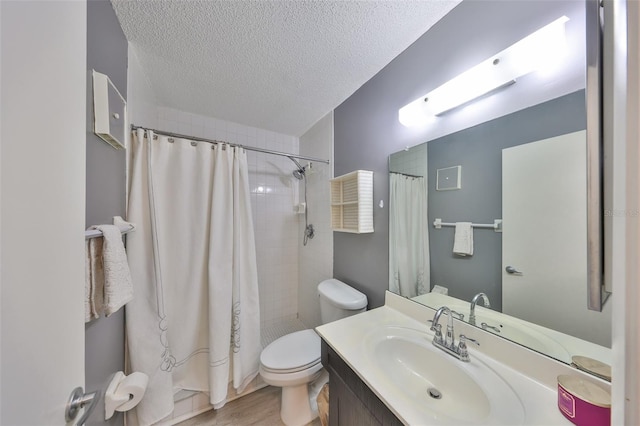 bathroom featuring a textured ceiling, toilet, vanity, and a shower with curtain