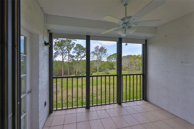 unfurnished sunroom with a ceiling fan