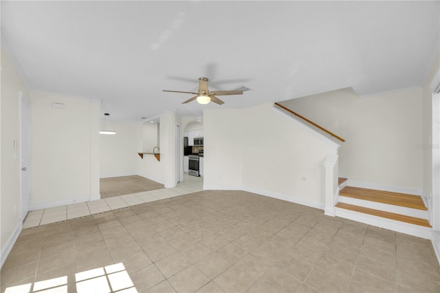 unfurnished living room featuring light tile patterned floors, baseboards, ceiling fan, and stairs