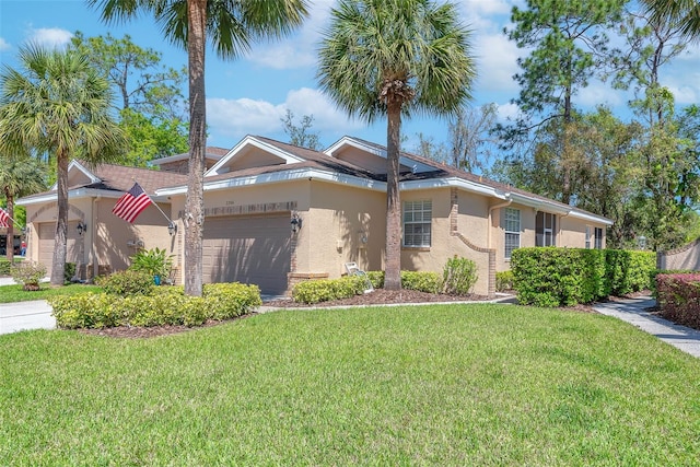 ranch-style home with a garage, stucco siding, driveway, and a front yard