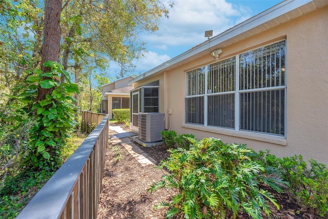 view of yard with cooling unit and fence