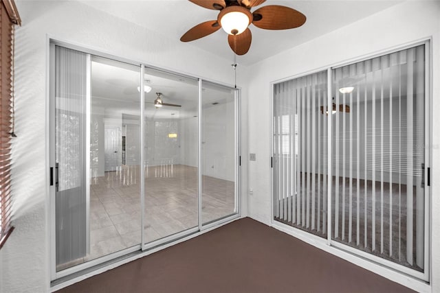 unfurnished sunroom featuring a ceiling fan