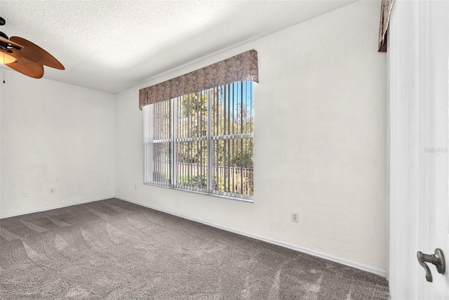 spare room featuring baseboards, carpet flooring, a textured ceiling, and a ceiling fan