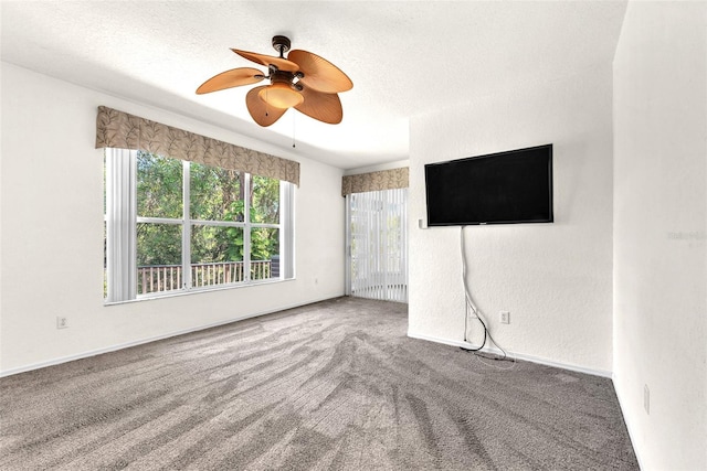 unfurnished living room featuring carpet flooring, a textured ceiling, ceiling fan, and a textured wall