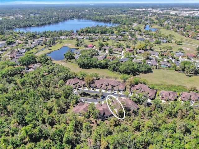 birds eye view of property with a forest view, a residential view, and a water view