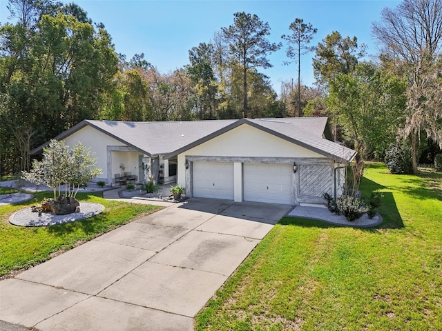 single story home featuring stucco siding, a front lawn, a garage, and driveway