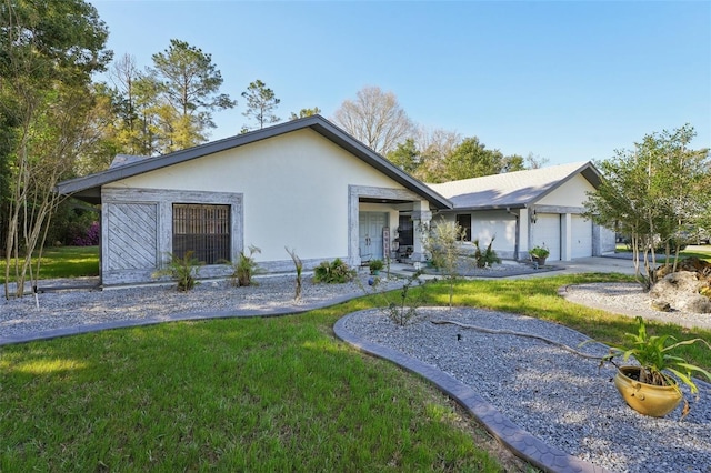 ranch-style home with a front lawn, concrete driveway, a garage, and stucco siding