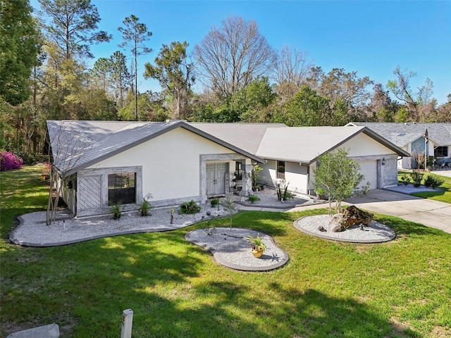 ranch-style house with stucco siding, a front yard, concrete driveway, and an attached garage