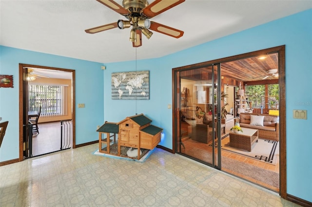 interior space featuring a ceiling fan and baseboards