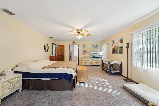 carpeted bedroom with visible vents and ceiling fan