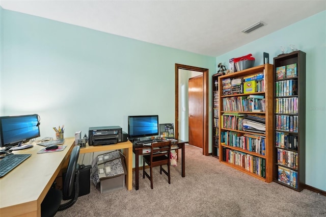 office space featuring visible vents and light carpet