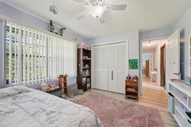 bedroom with wood finished floors, a closet, and ceiling fan