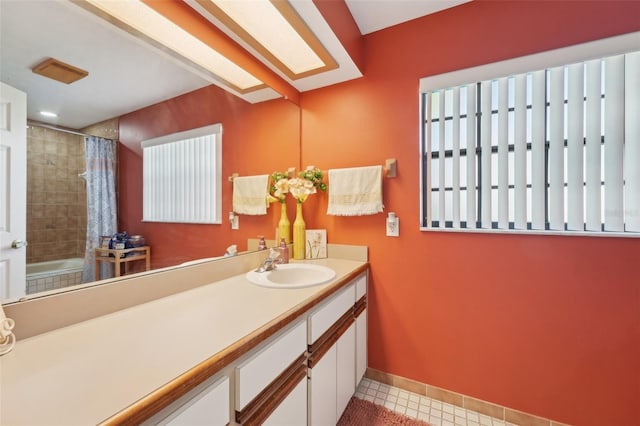 full bath with tile patterned flooring, vanity, and baseboards