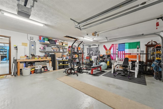 garage with electric panel, a workshop area, and a garage door opener