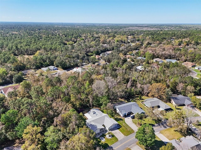 birds eye view of property with a view of trees and a residential view