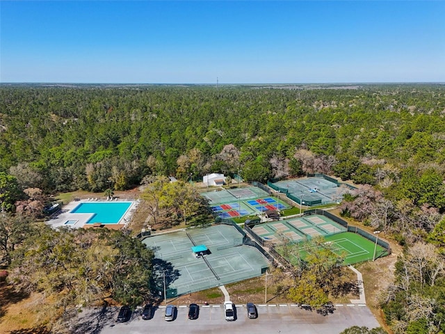 bird's eye view with a wooded view