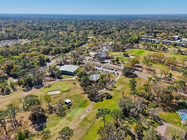 aerial view featuring view of golf course and a view of trees