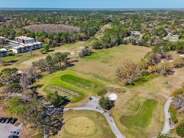 bird's eye view featuring a view of trees and golf course view