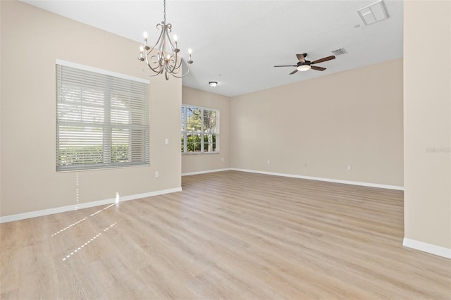 empty room featuring light wood finished floors, visible vents, ceiling fan with notable chandelier, and baseboards