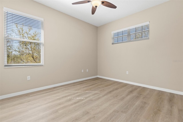 unfurnished room with light wood-style flooring, baseboards, and ceiling fan